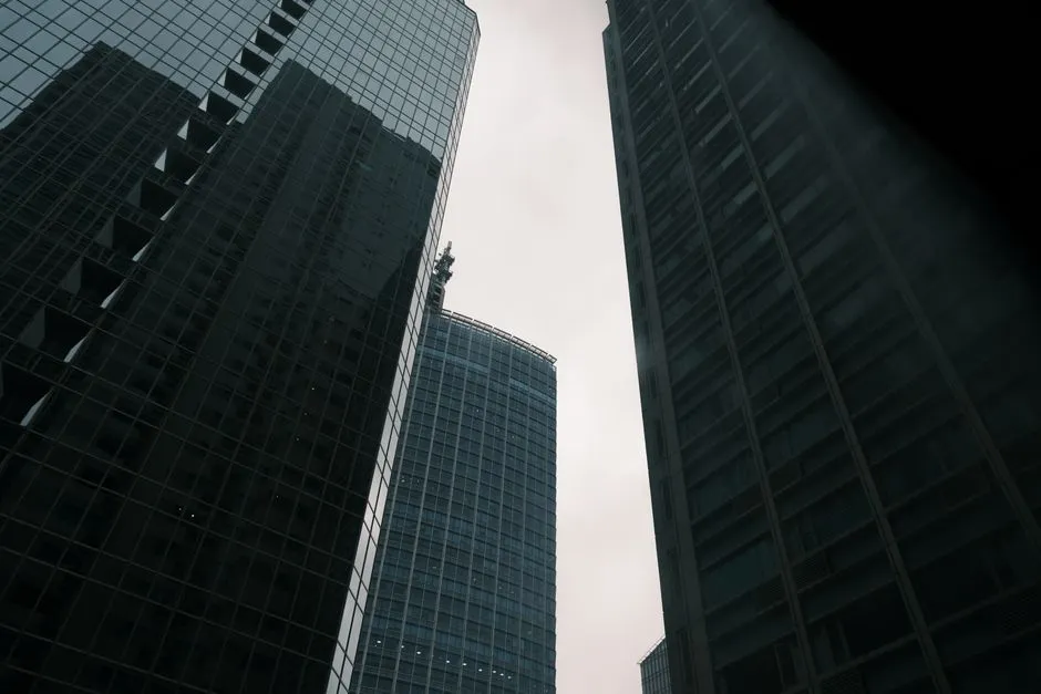 View of modern skyscrapers reaching into an overcast sky, emphasizing urban architecture.