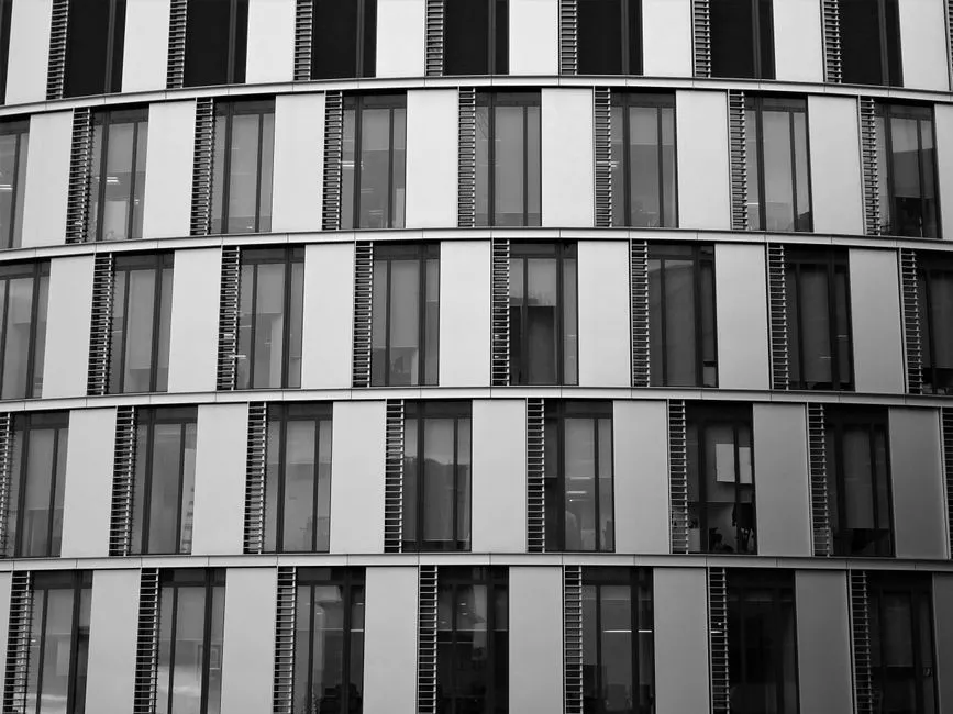 Close-up view of a contemporary office building exterior with glass and steel elements.