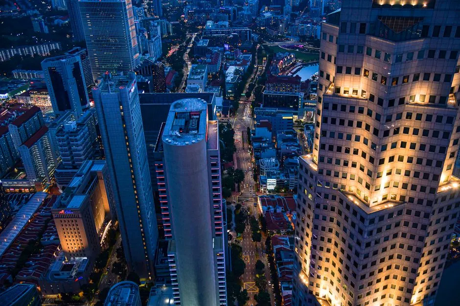 Stunning aerial view of Singapore's skyline at night, showcasing illuminated skyscrapers and city lights.